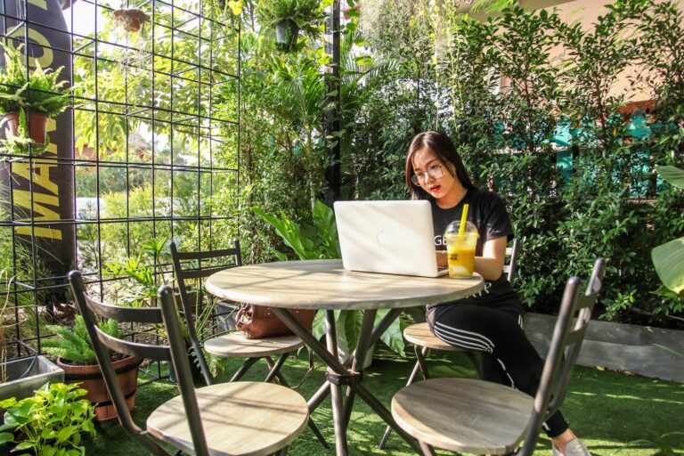 DG Speaks - Travel - Money - Woman sitting on chair while using laptop