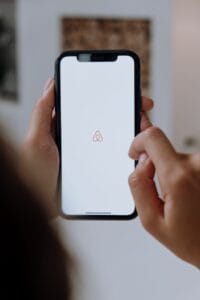 Is Airbnb Hosting Worth It in 2026? An Honest Look After 14 Years - DG Speaks - Money - Airbnb - Phone with Airbnb ap loading