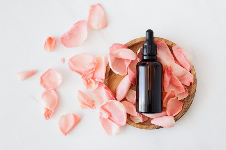 DG Speaks - Money - Consulting - Cost Analysis - composition of cosmetic bottle with pink rose petals and wooden plate