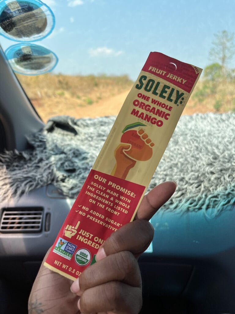 DG Speaks - Money - Food Consulting - Packaging - Mercedes showcasing Solely Mango bar’s smart packaging during a car ride in Zambia.