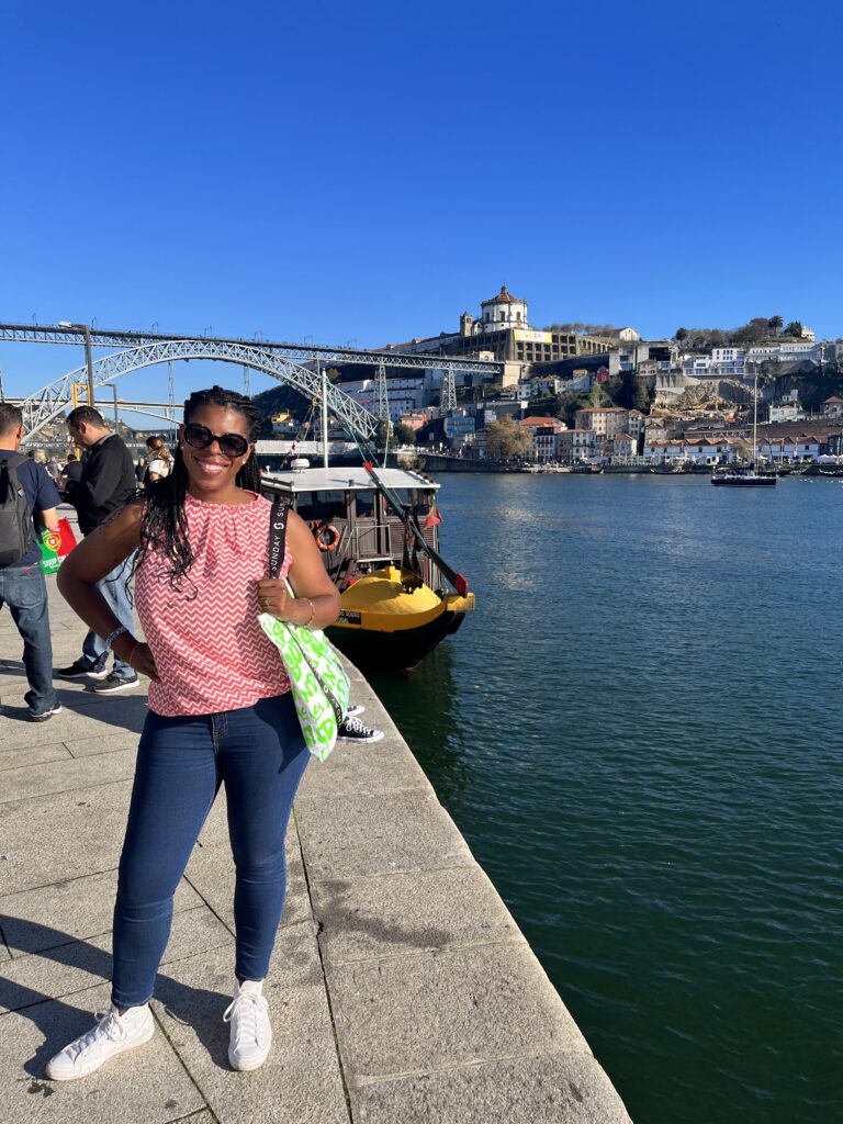 DG Speaks - Travel Mercedes posing in Porto in front of the Dom Luís I Bridge