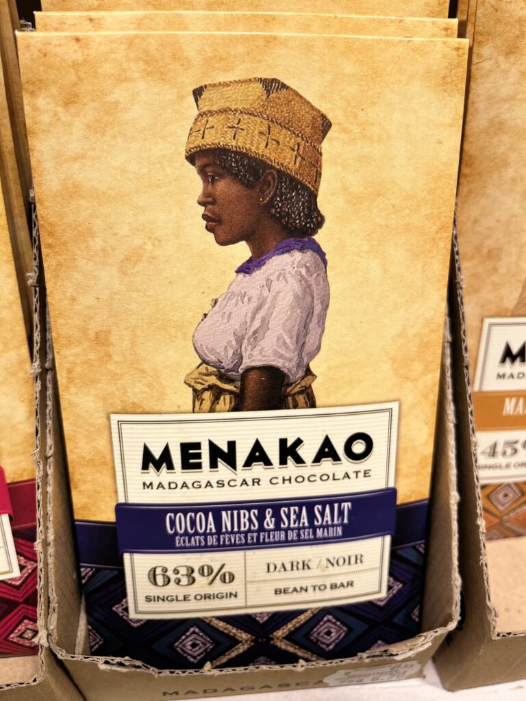 The art of food branding: Female cacao farmer proudly displays Menakao chocolate packaging.