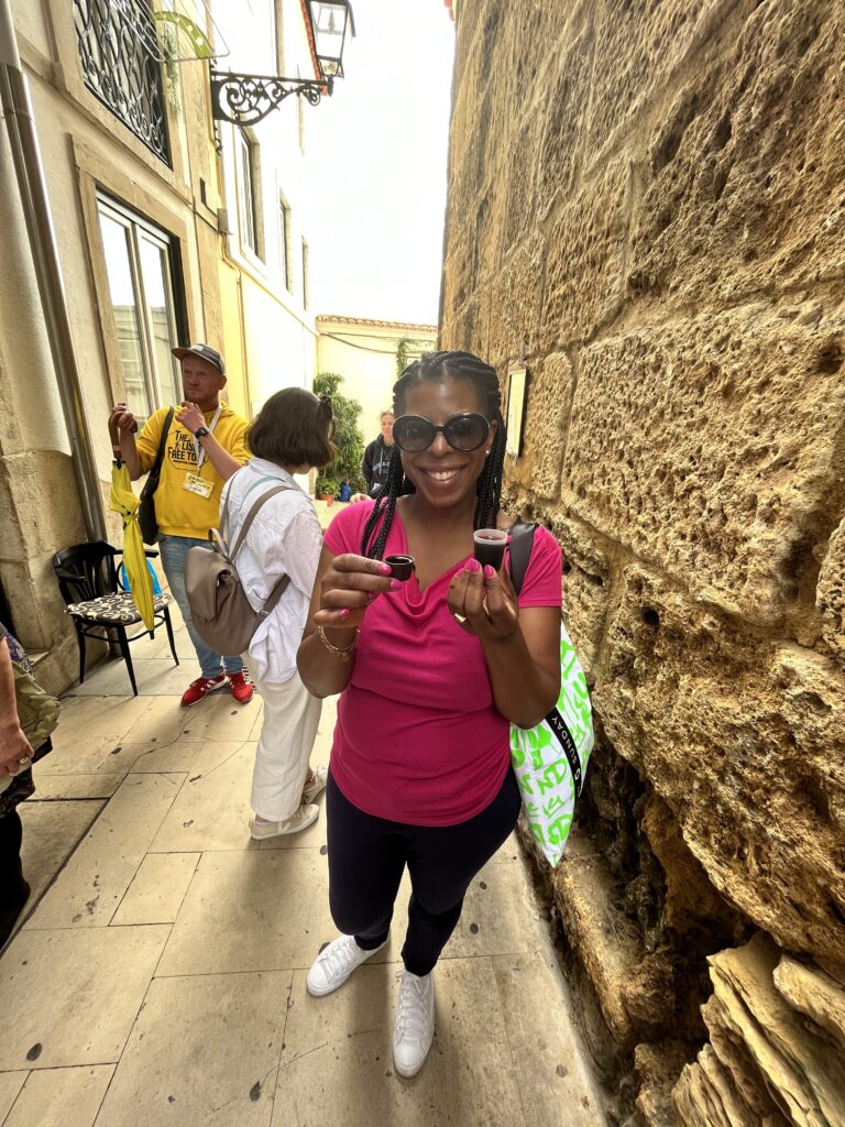 DG Speaks - Travel - Mercedes enjoys Ginja Lisboa on a Guru Walk tour, soaking in the rich flavors of Lisbon.