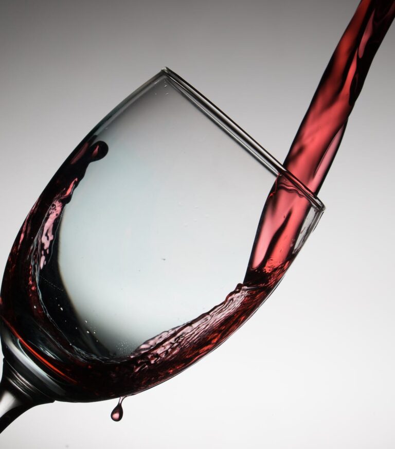 DG Speaks - Wine - Sustainable Sips - Red wine pours into a crystal-clear glass, embodying the art of sustainable indulgence.