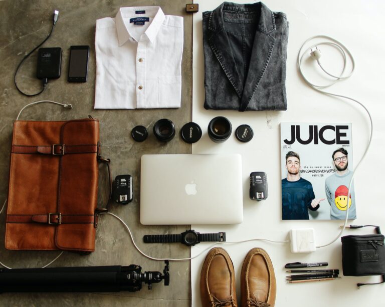 DG Speaks - Travel - Ultimate Packing List - brown leather bag clothes and macbook