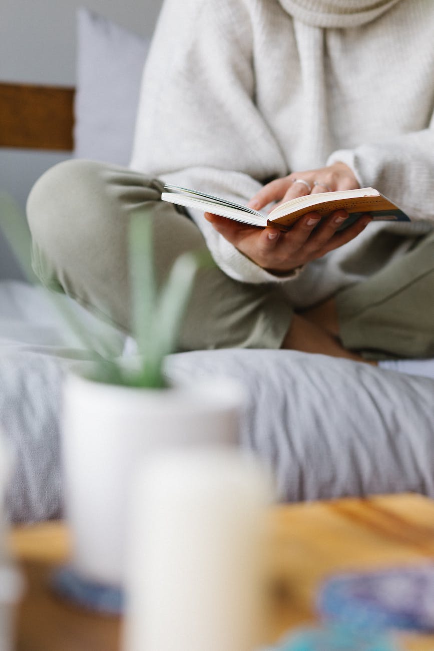 DG Speaks - Lifestyle - Faceless woman reading book on comfortable bed at home in January
