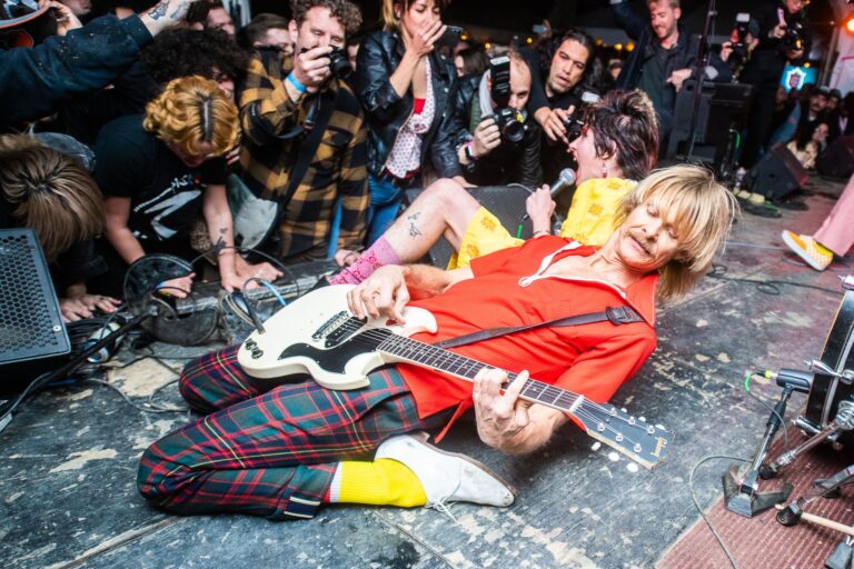 DG Speaks - Pop Culture - SXSW Music Festival 2023 - guitarist playing on the ground before fans at SXSW 2022