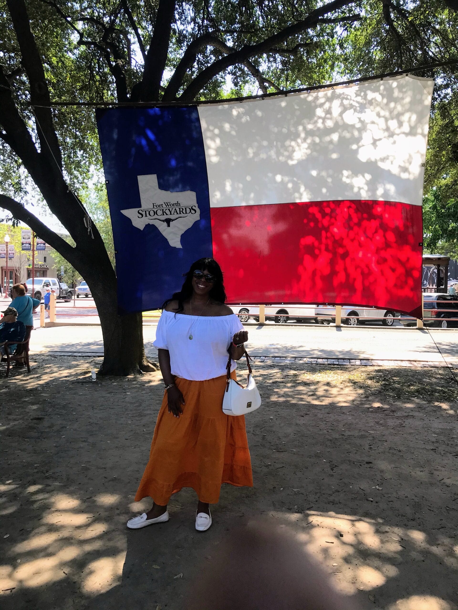 Mercedes Diane Griffin Forbes posing proudly by the Texas flag.