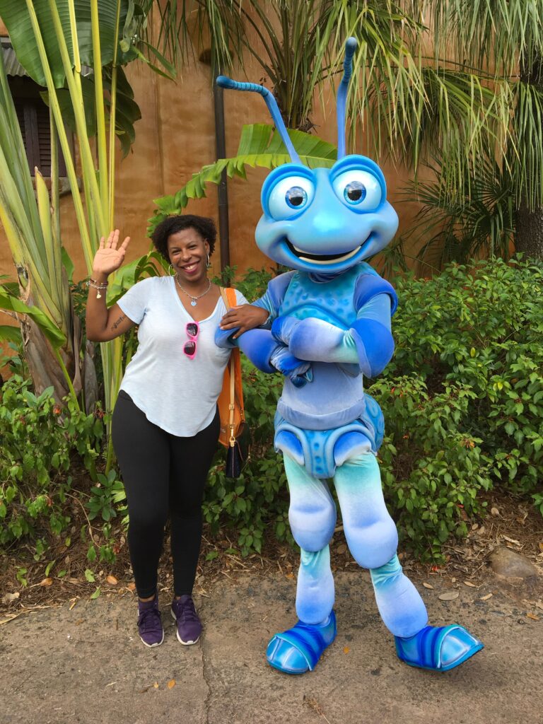 Mercedes having fun with her Disneyland ticket posing with blue ant