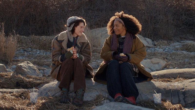 Agnes and her friend in Sorry, Baby Sundance 2025, sitting together in the woods, sharing a quiet moment of connection, reflection, and emotional support.