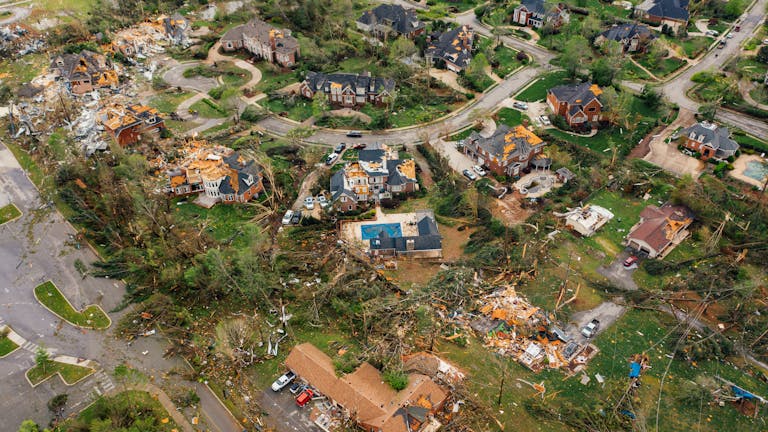 Aerial view showing severe tornado damage in Chattanooga, Tennessee neighborhood for tornado watch vs warning.
