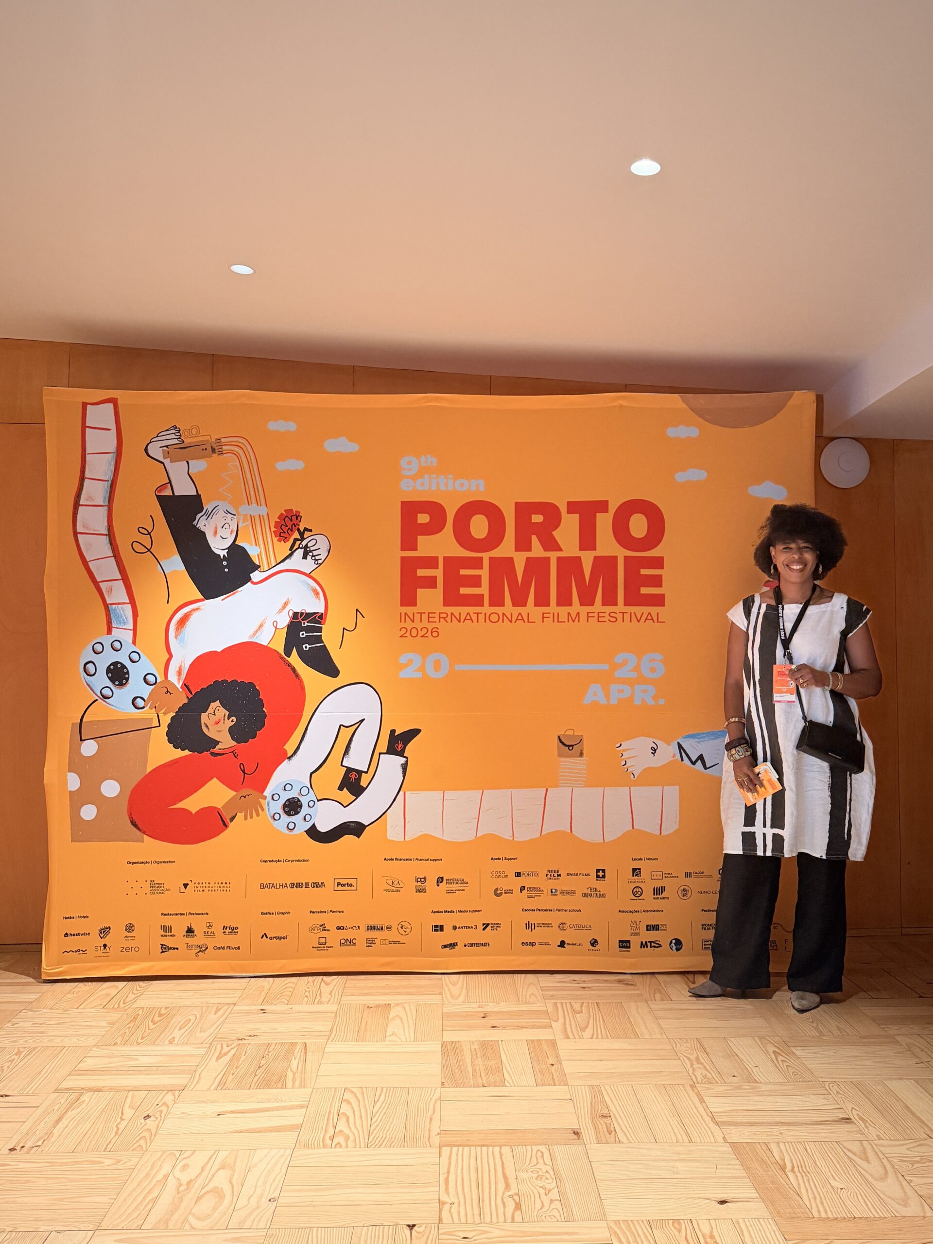 Mercedes opening night of the Porto Femme Film Festival standing in front of the banner.