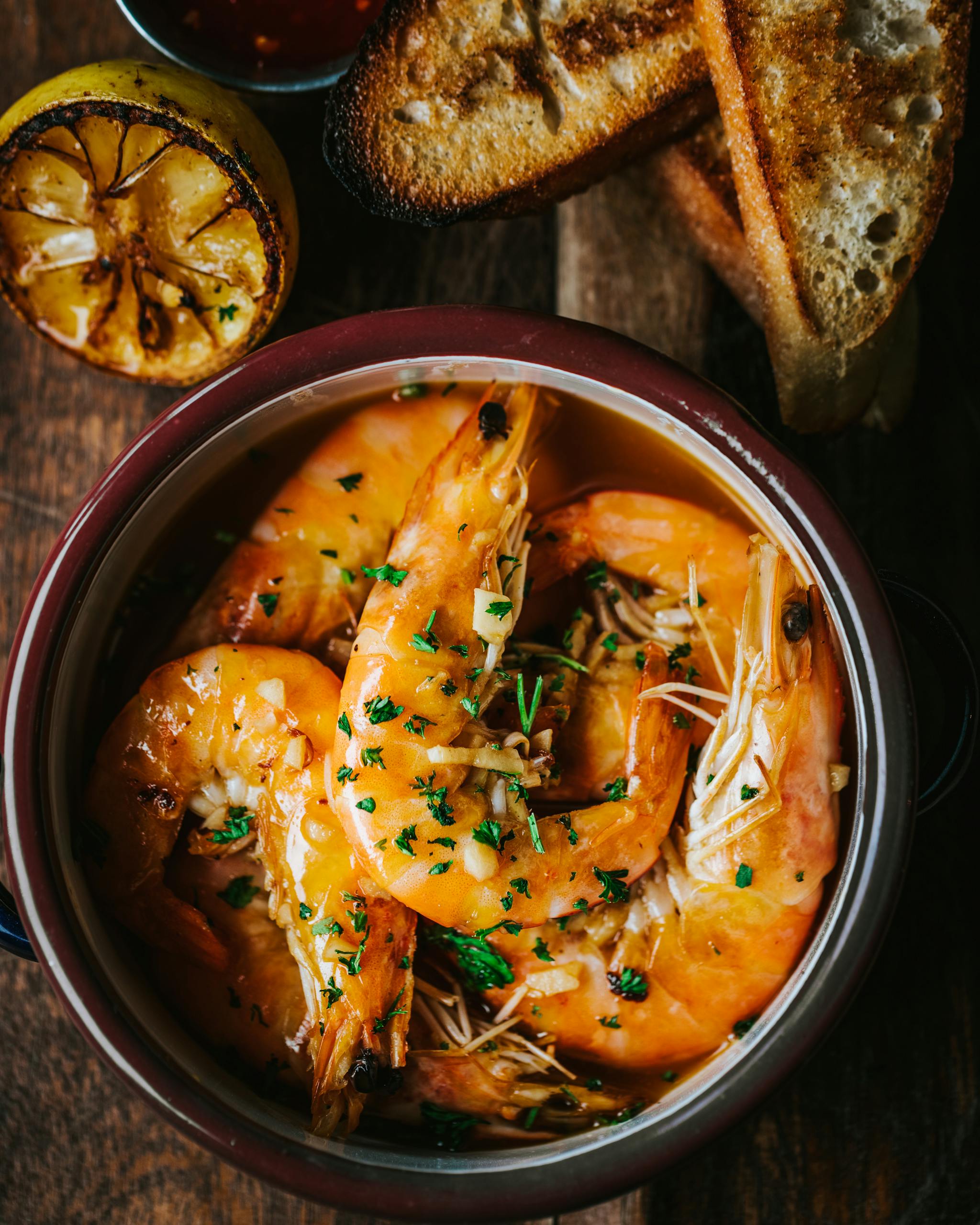 National Shrimp Day. Delicious gourmet shrimp in sauce served with grilled lemon and crispy bread.