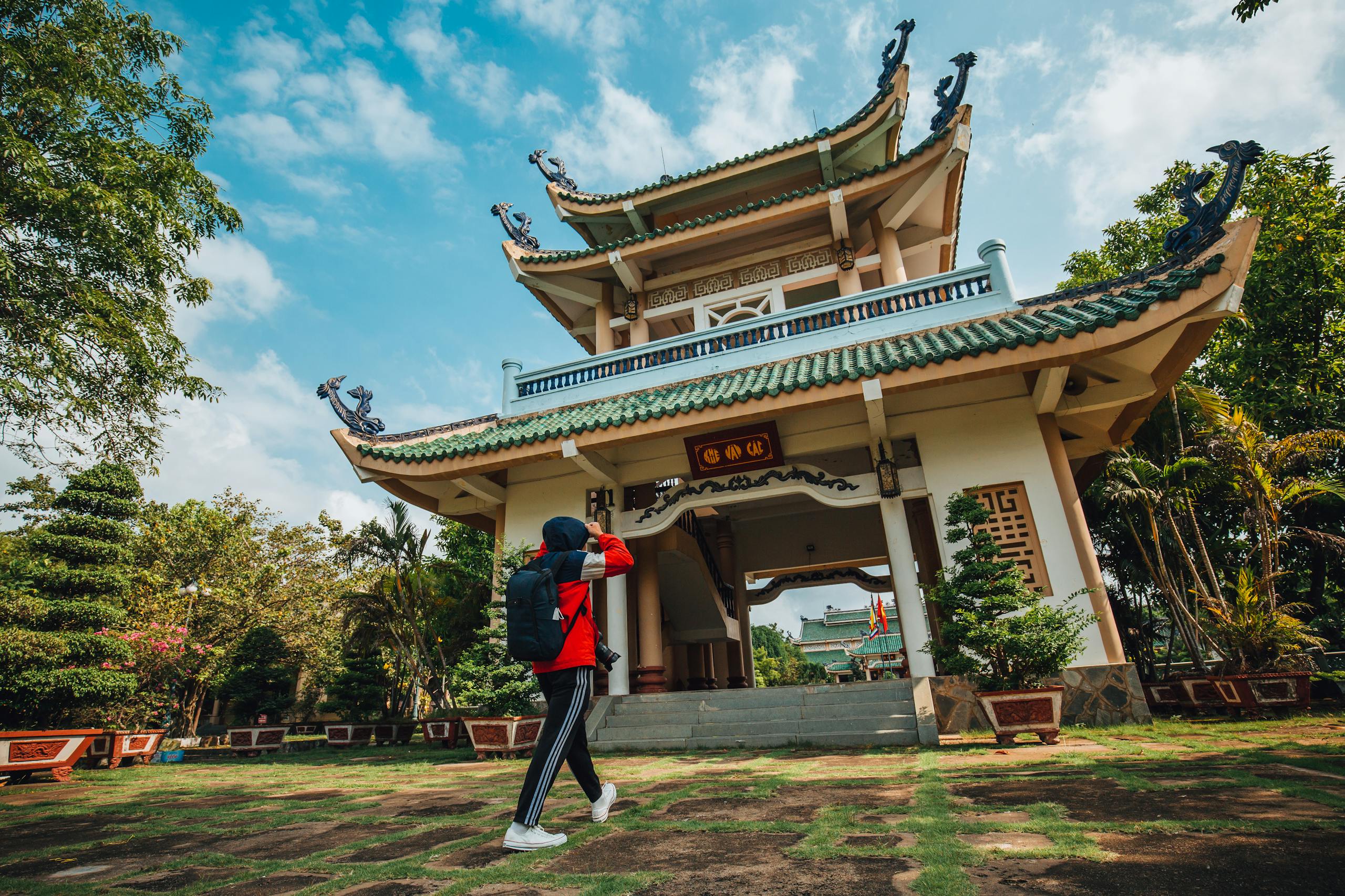 Vietnam travel destination - A person explores the iconic Tran Bien Temple of Literature in Vietnam, showcasing its traditional architecture.