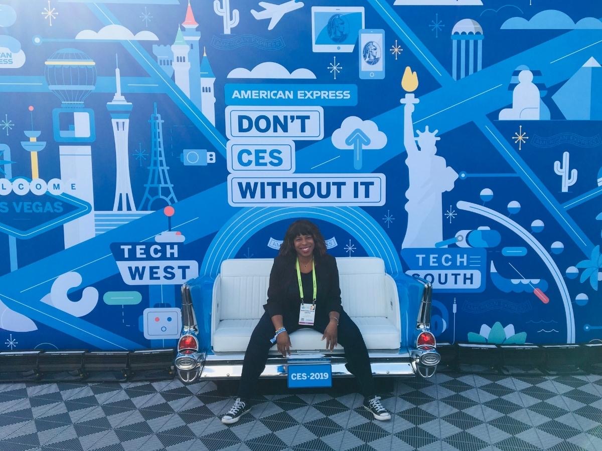 Mercedes Diane Griffin Forbes attending CES 2020 in Las Vegas, surrounded by futuristic technology displays and digital branding that capture the atmosphere of innovation, mobility, and modern tech culture.