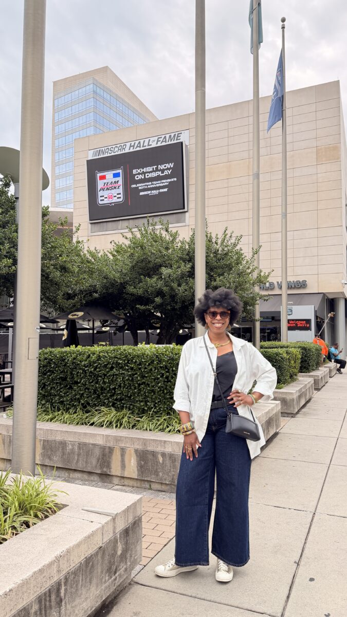 Mercedes standing in front of the NASCAR Hall of Fame