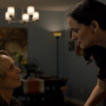 Actress playing cello beside older woman during an emotional scene in The Birthday Gift short film