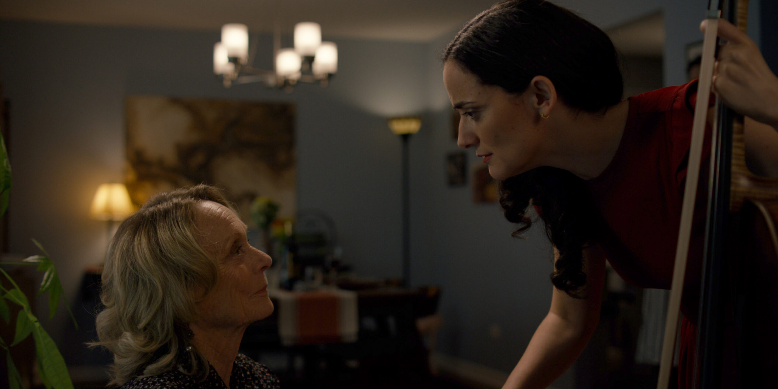 Actress playing cello beside older woman during an emotional scene in The Birthday Gift short film