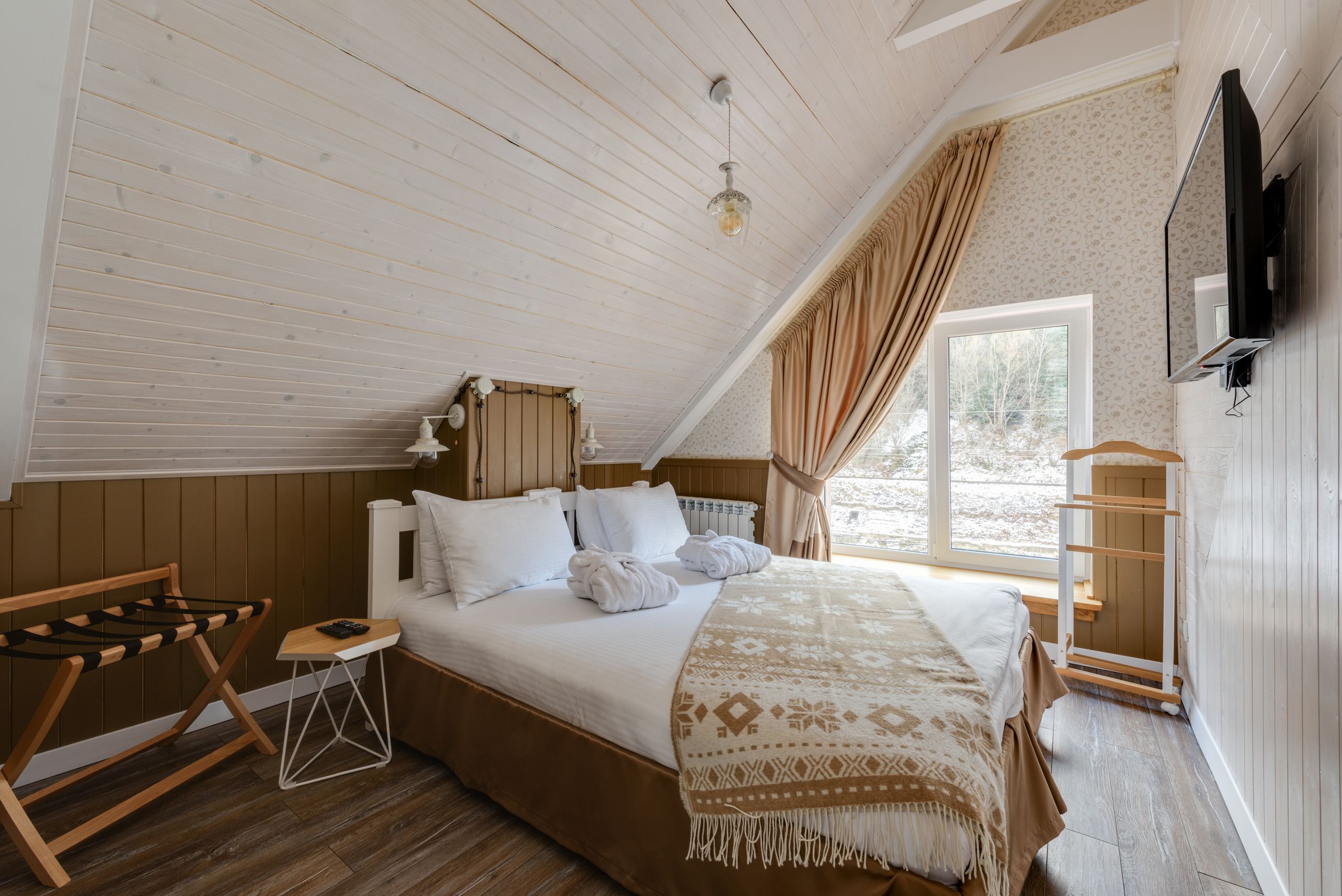 Airbnb Bedroom Essentials: How to Create a Space Guests Never Want to Leave - Inviting attic bedroom with modern design and natural light for a relaxing stay.