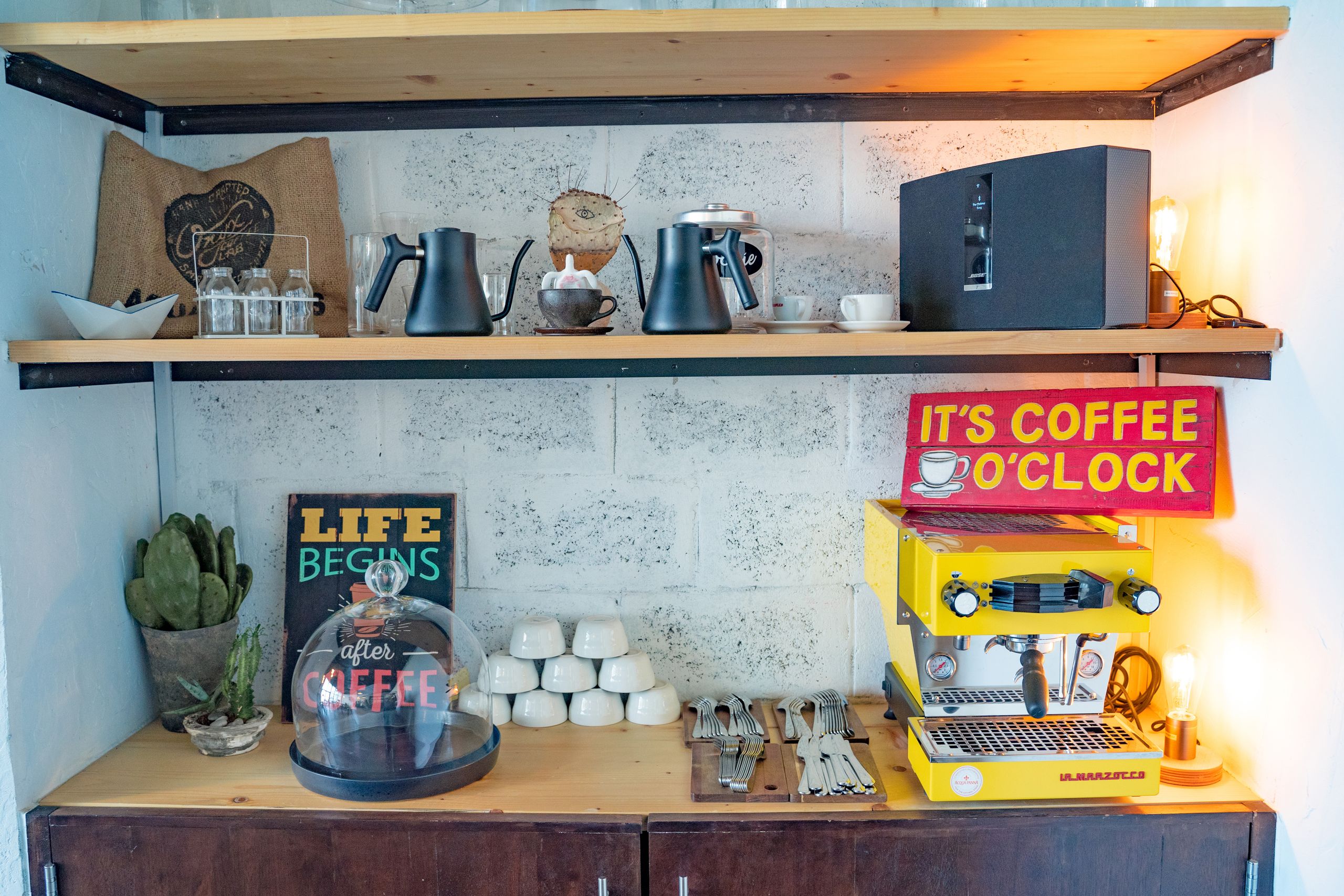 Airbnb Coffee Station Ideas: Create a Memorable Welcome for Every Guest - Stylish café setup featuring espresso machine and coffee decor.