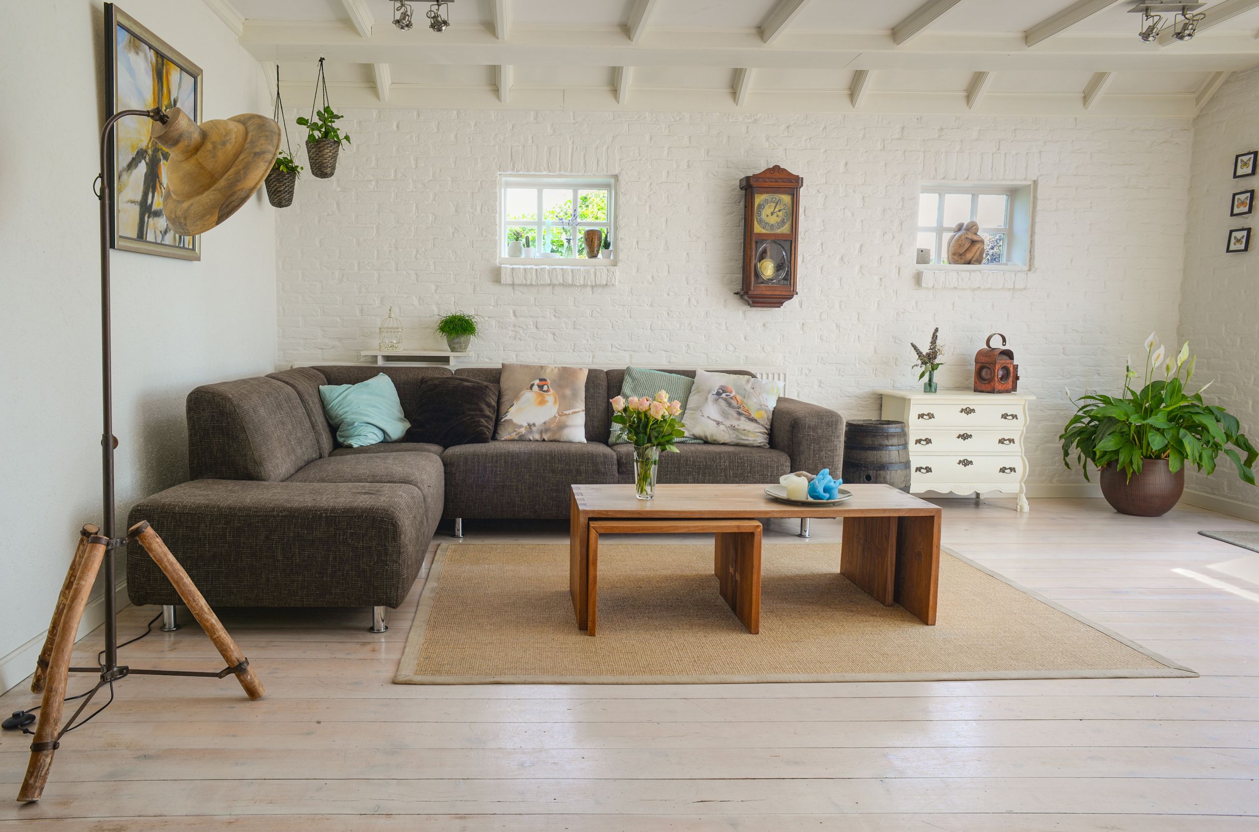 Airbnb Essentials Checklist: Everything You Need Before Your First Guest Arrives - Stylish living room interior featuring a cozy couch, decor accents, and natural elements.