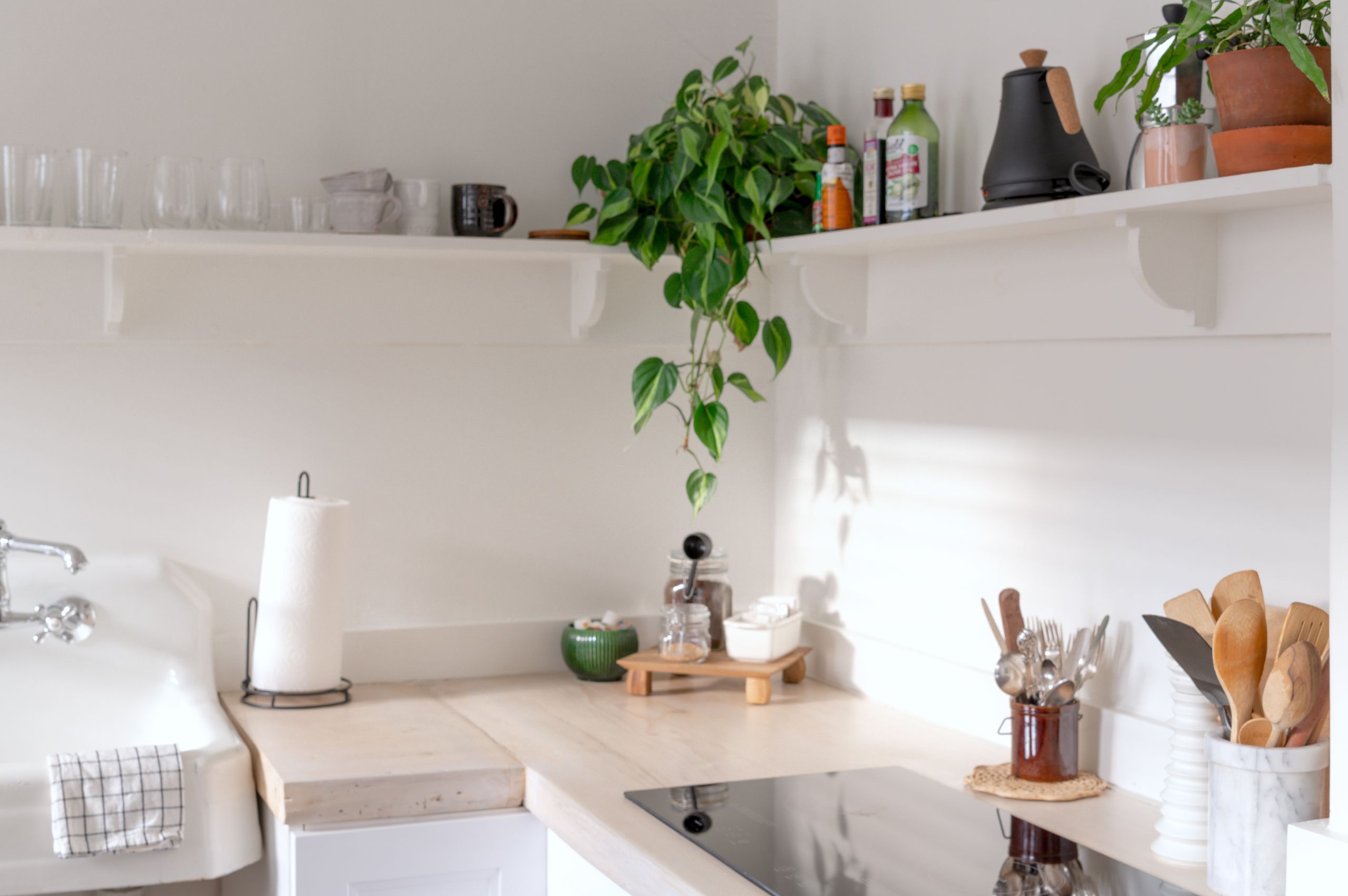 Airbnb Kitchen Essentials: How to Create a Guest-Friendly Space - Bright and airy kitchen interior showcasing minimalist design and natural decor elements.