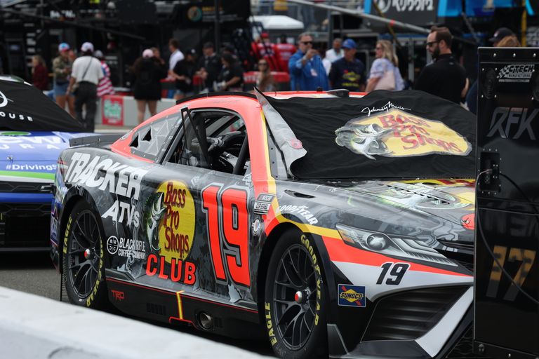 Close-up of a NASCAR race car in the paddock area during a racetrack event.