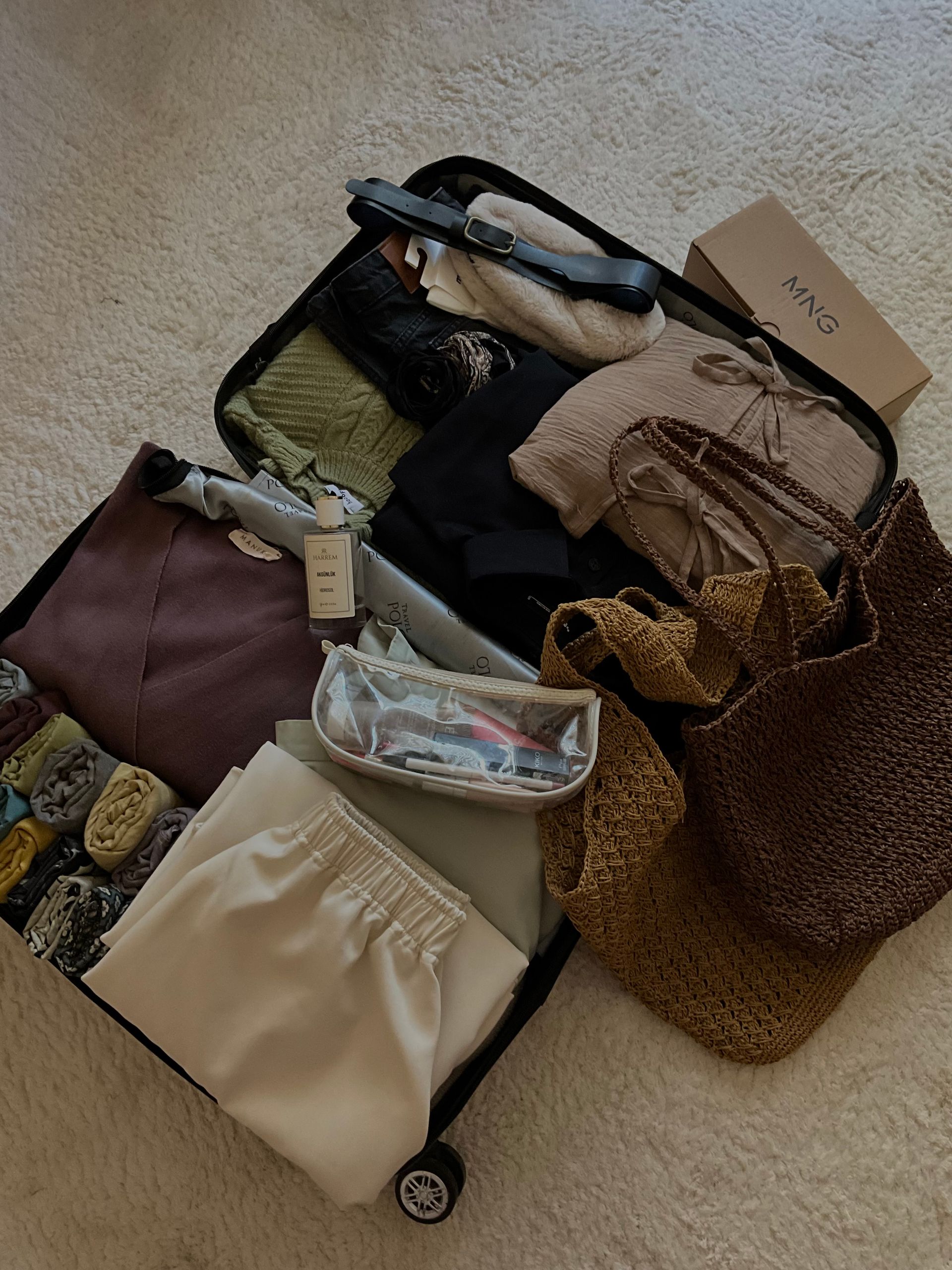 Sustainable Travel Essentials I Actually Pack - A suitcase neatly packed with clothes, accessories, and travel essentials for a chic vacation.