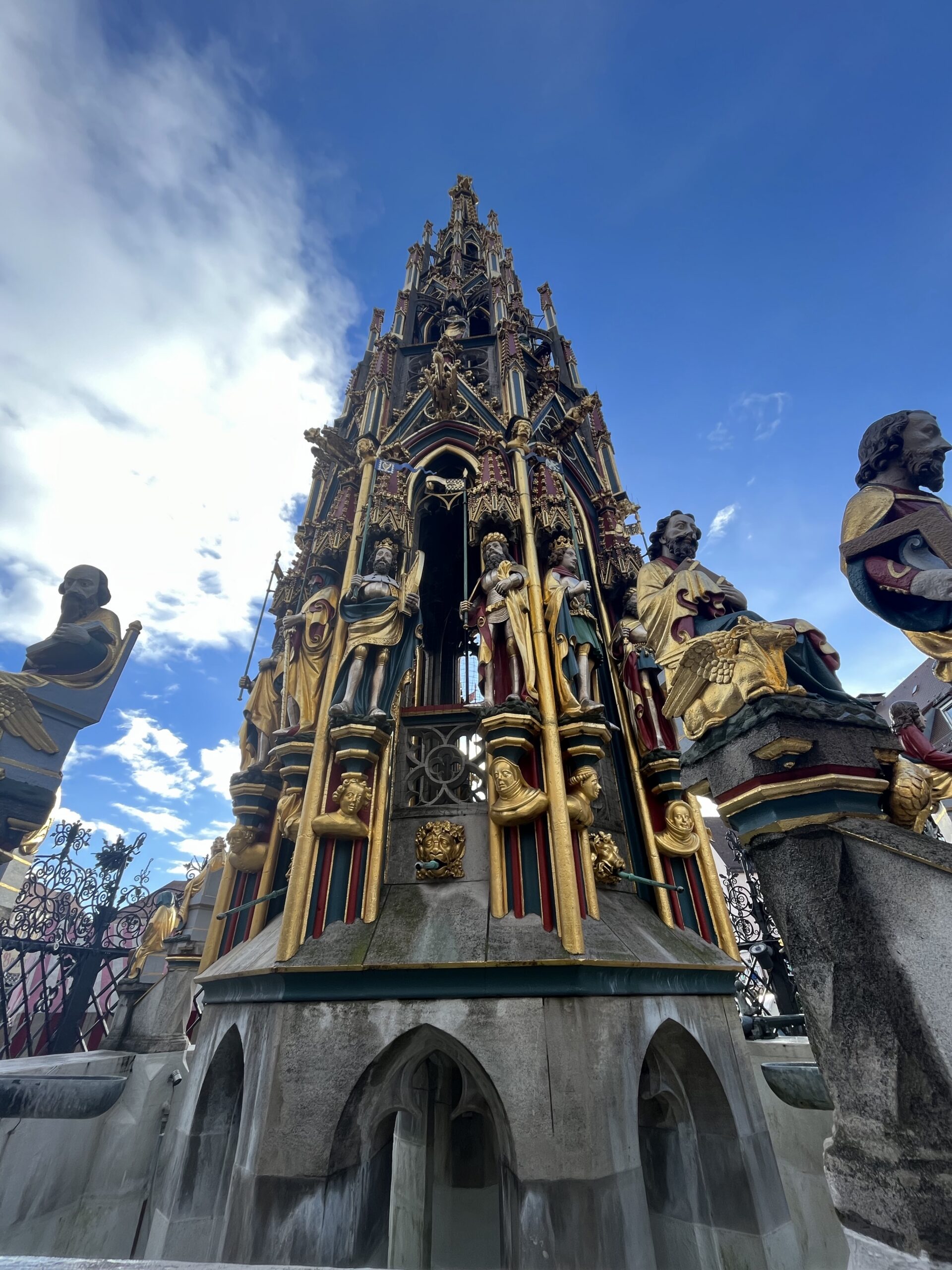 Colorful Gothic figures and gilded details on the Schöner Brunnen in Nuremberg Hauptmarkt
