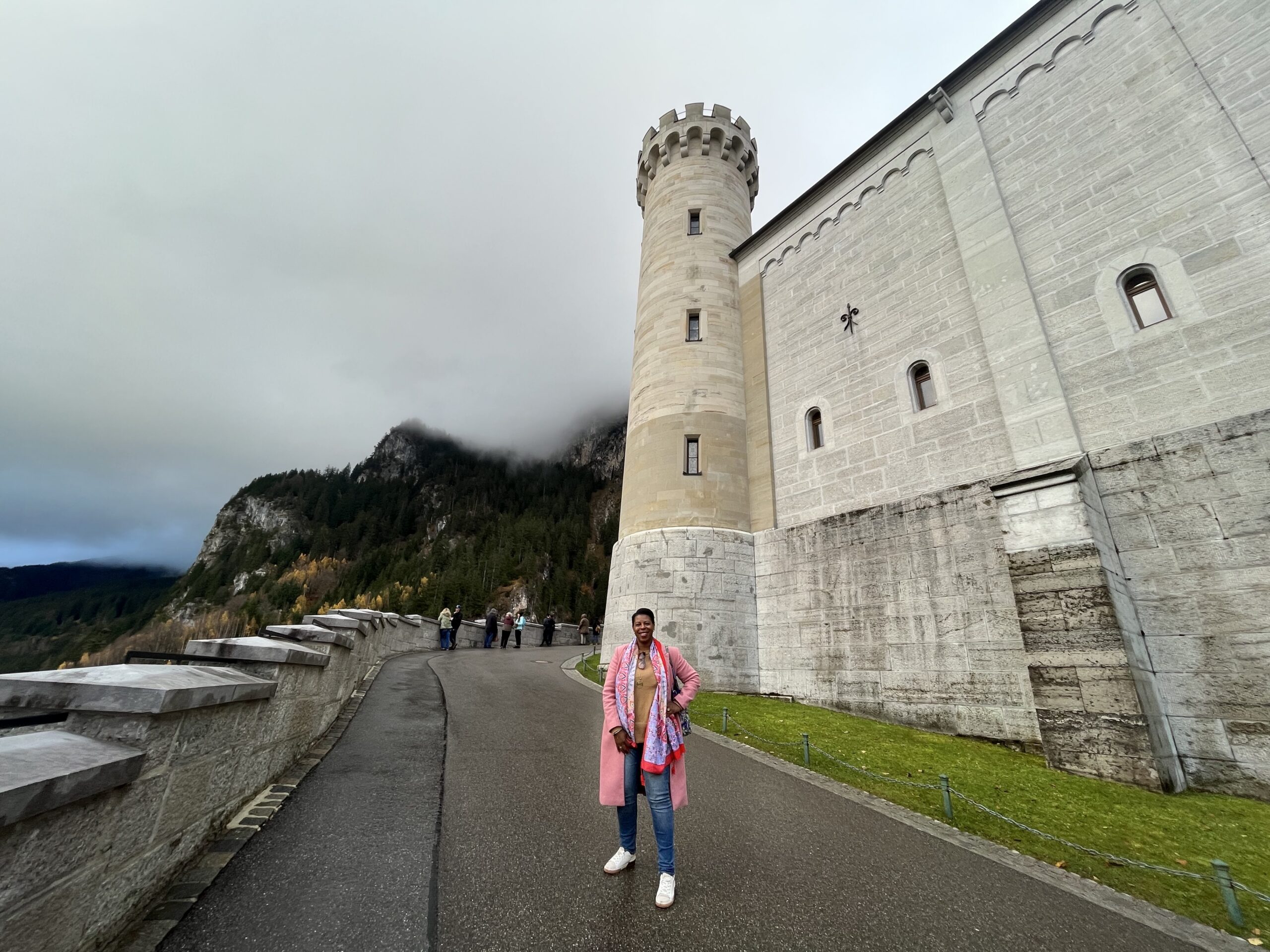 Black woman traveler outside Neuschwanstein Castle