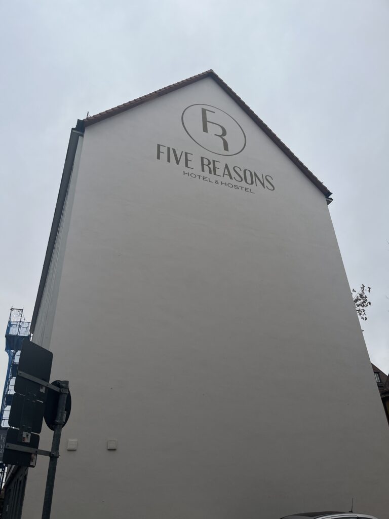 Five Reasons Hotel and Hostel sign painted on a white building in Nuremberg Germany