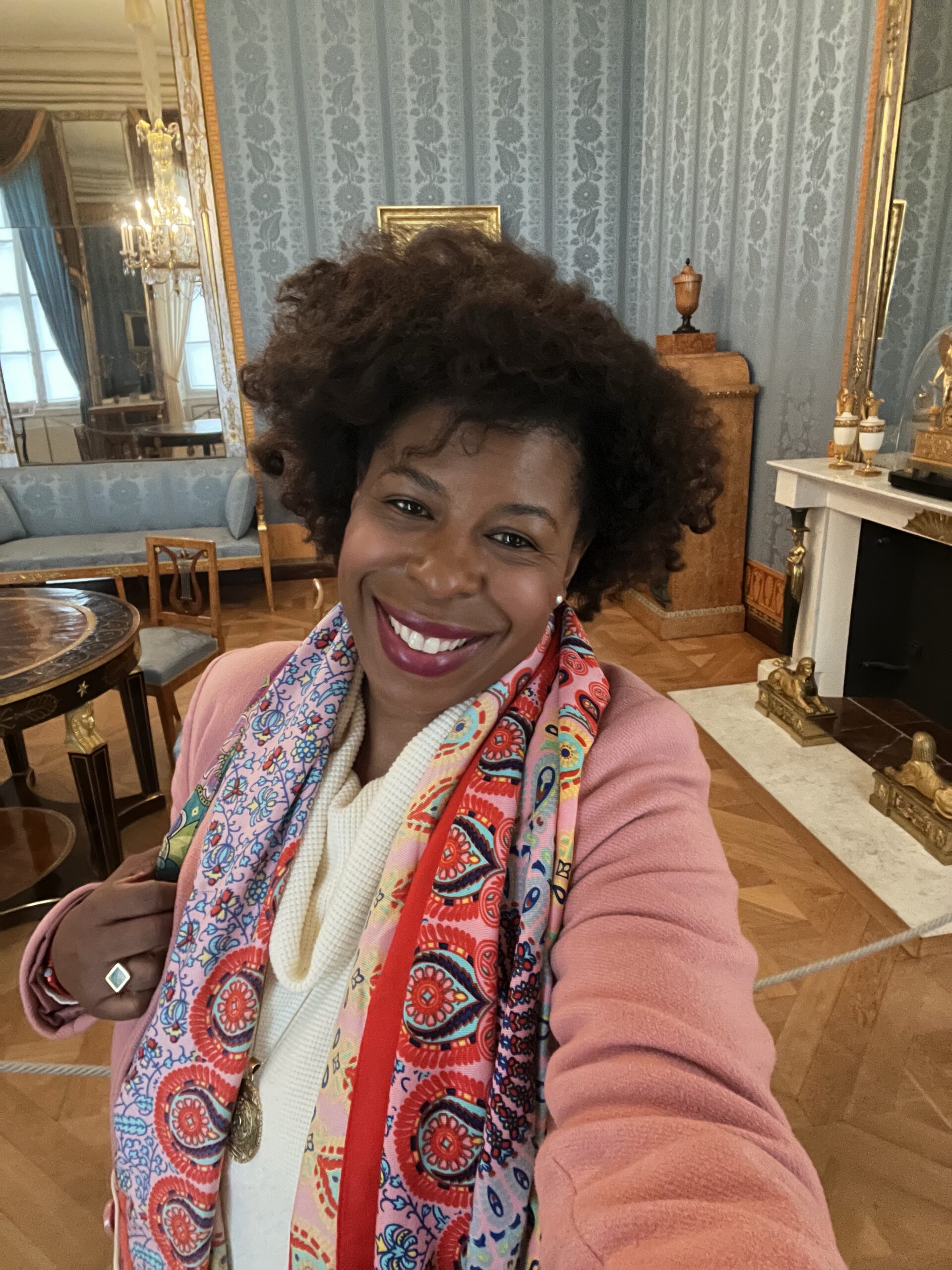 Black woman traveler inside a blue royal apartment at the Munich Residenz