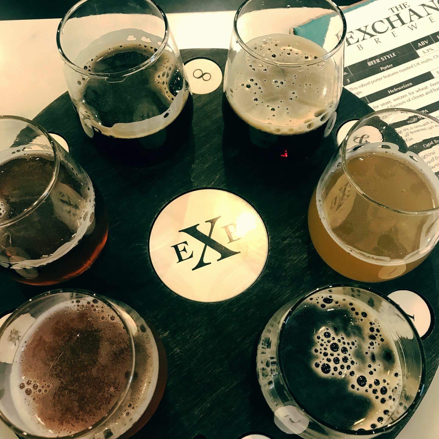 Craft beer flight at The Exchange Brewery featuring a selection of house-brewed beers