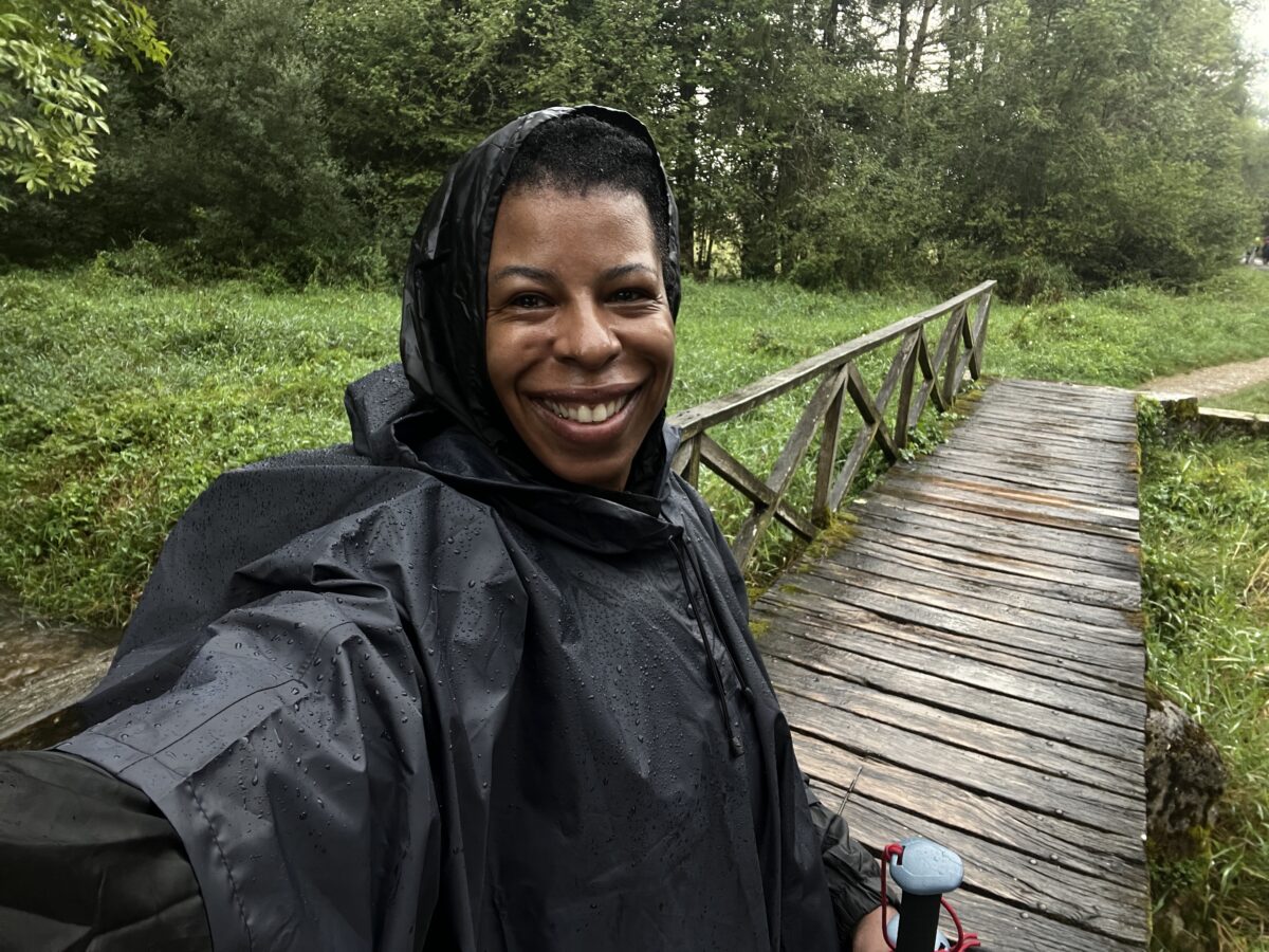 Mercedes on the Camino trail on a rainy day wearing her poncho
