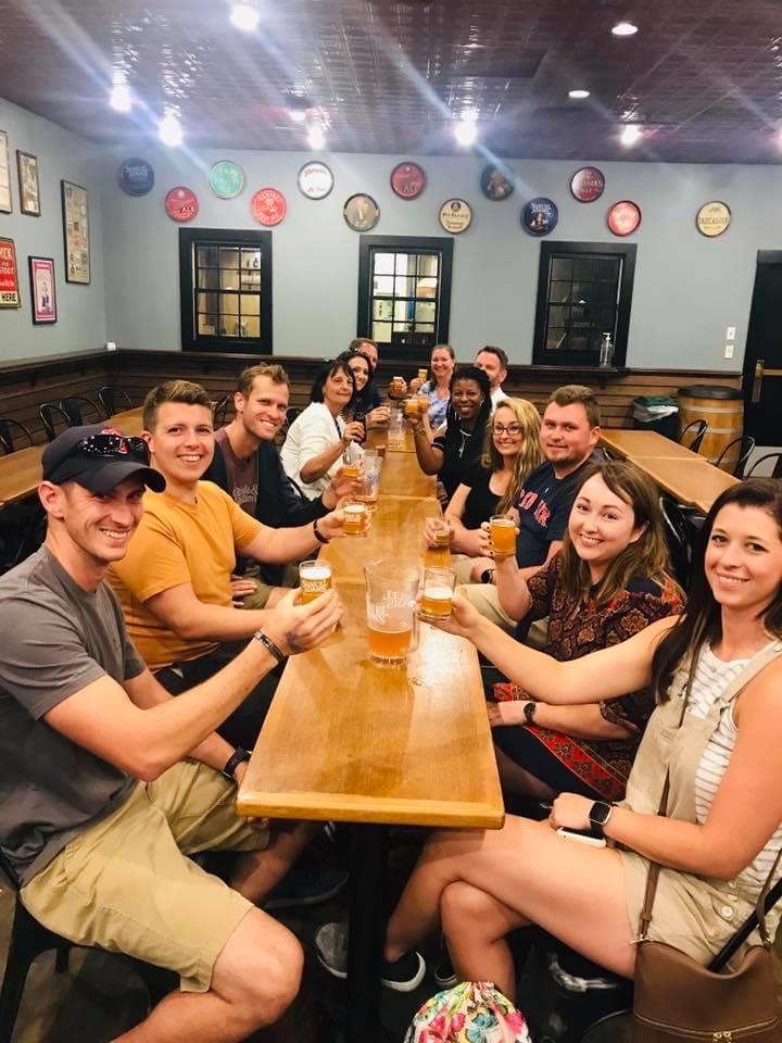 Sam Adams brewery tour group enjoying craft beer together during a guided tasting