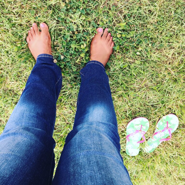 Mercedes walking on grass with bare feet