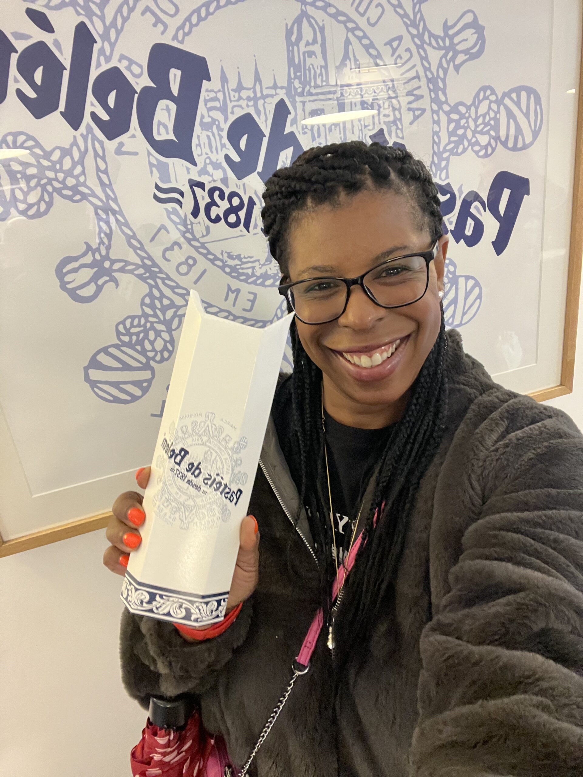 Original Pastéis de Belém bakery in Lisbon, Portugal with Mercedes Diane Griffin Forbes holding the iconic pastry box