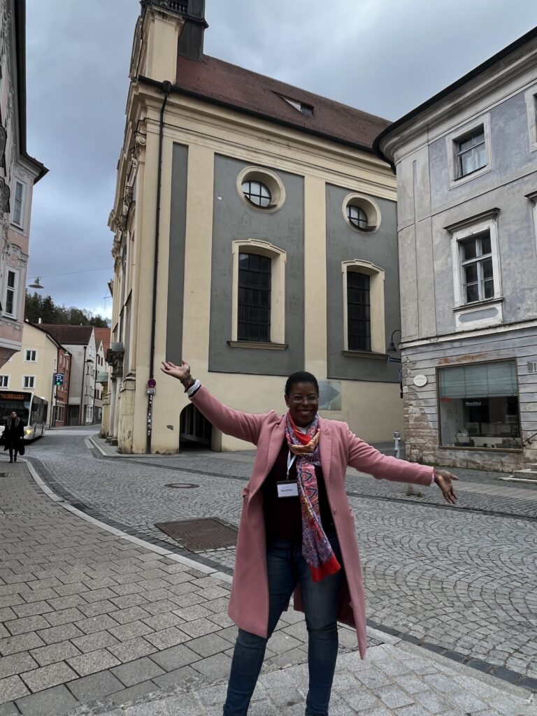 Solo traveler walking through a European city reflecting on leadership and personal growth