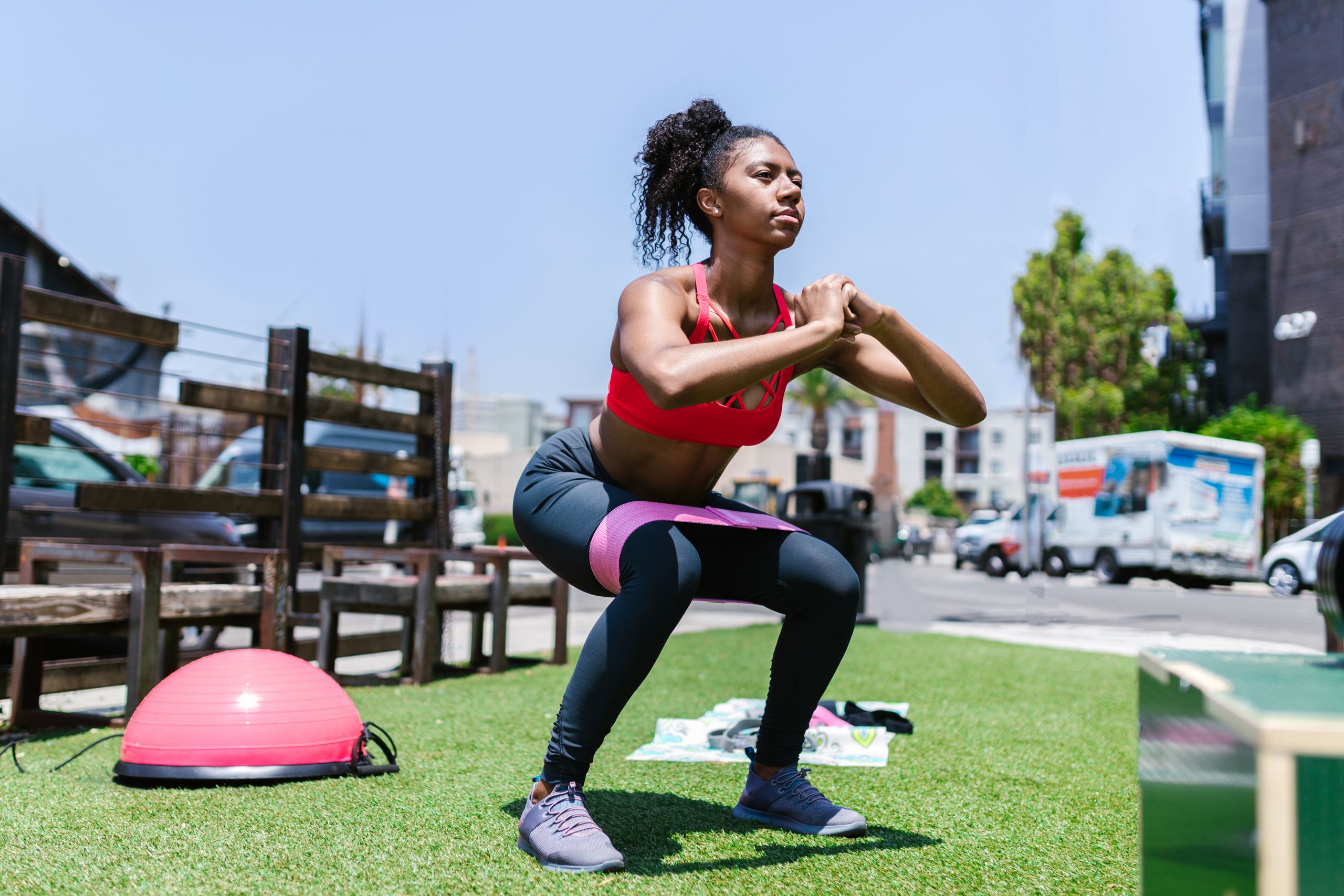 Black Women Fitness Focus Group - African American woman exercising with a resistance band outdoors.