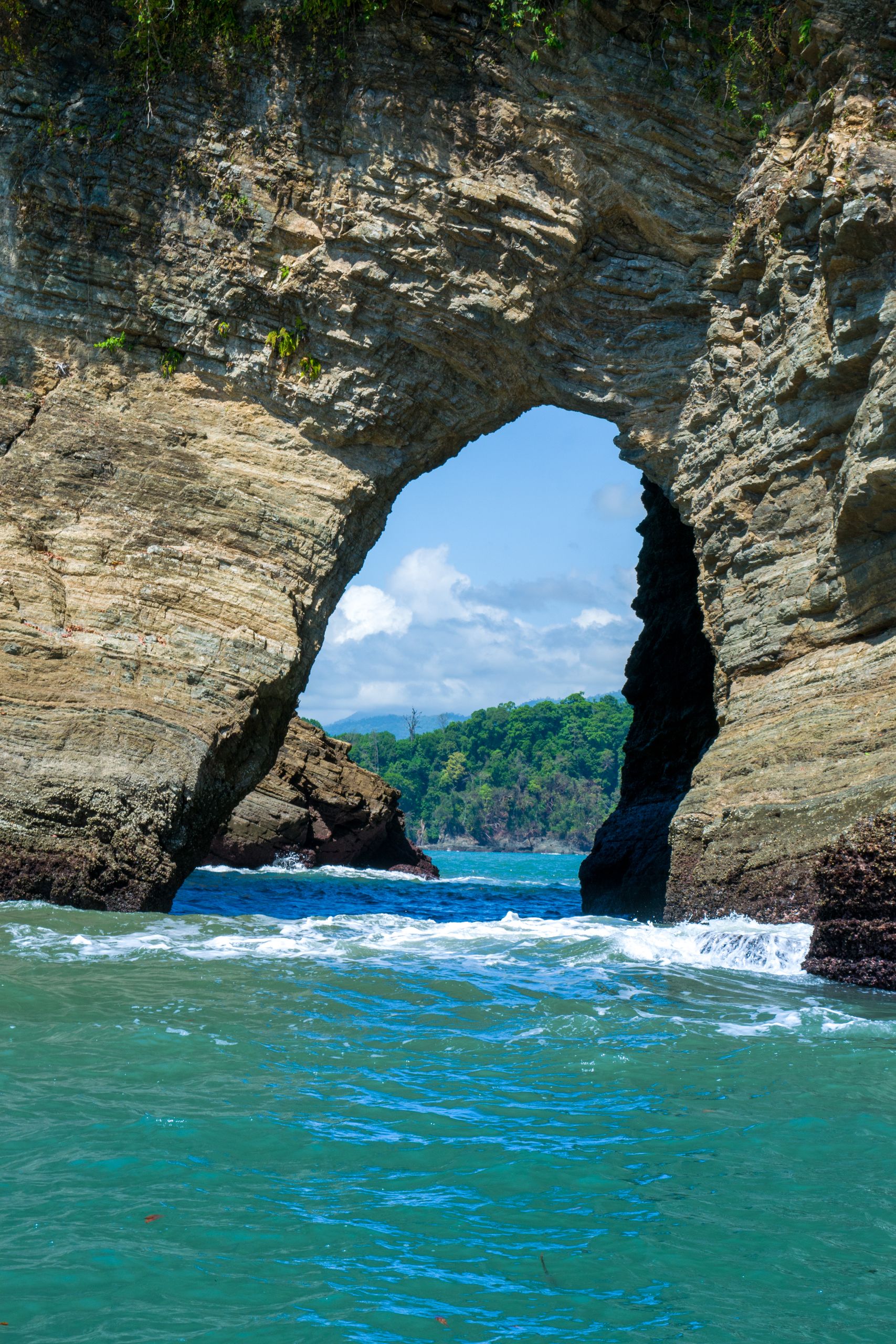 Costa Rica Travel Guide - Explore the stunning natural rock arch formation at Puntarenas, Costa Rica's beautiful coastline.