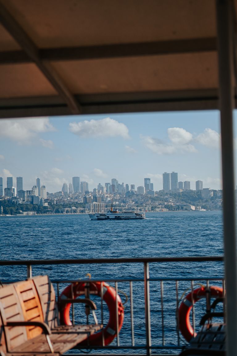 Ferry Ride Teaches Me About Crossing Over - Stunning city skyline as seen from a ferry crossing the ocean on a sunny day.