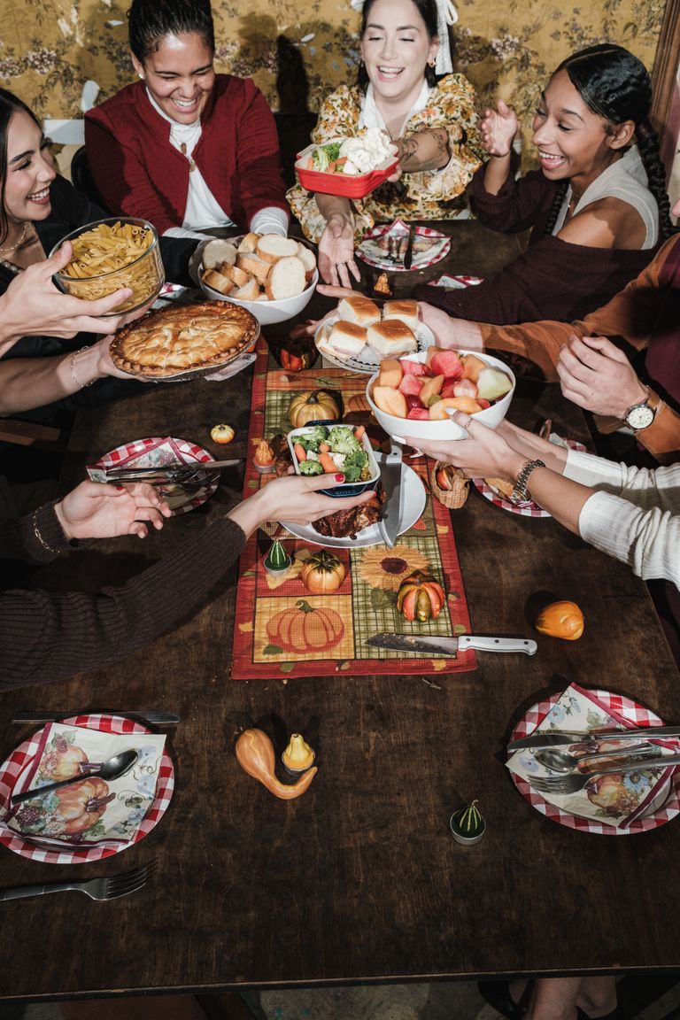Gathering Requires More Than Food - A joyful group of friends celebrating Thanksgiving with a delicious feast.