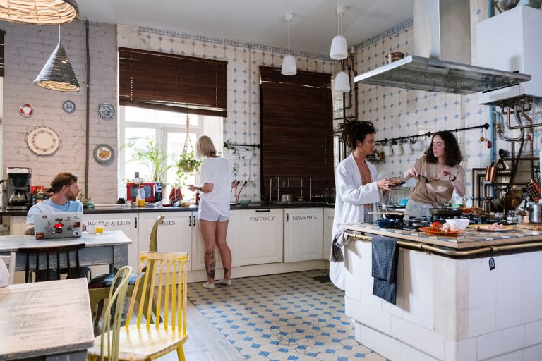 Good Hostel Kitchen - Friends enjoying a cozy day cooking together in a stylish kitchen setting.