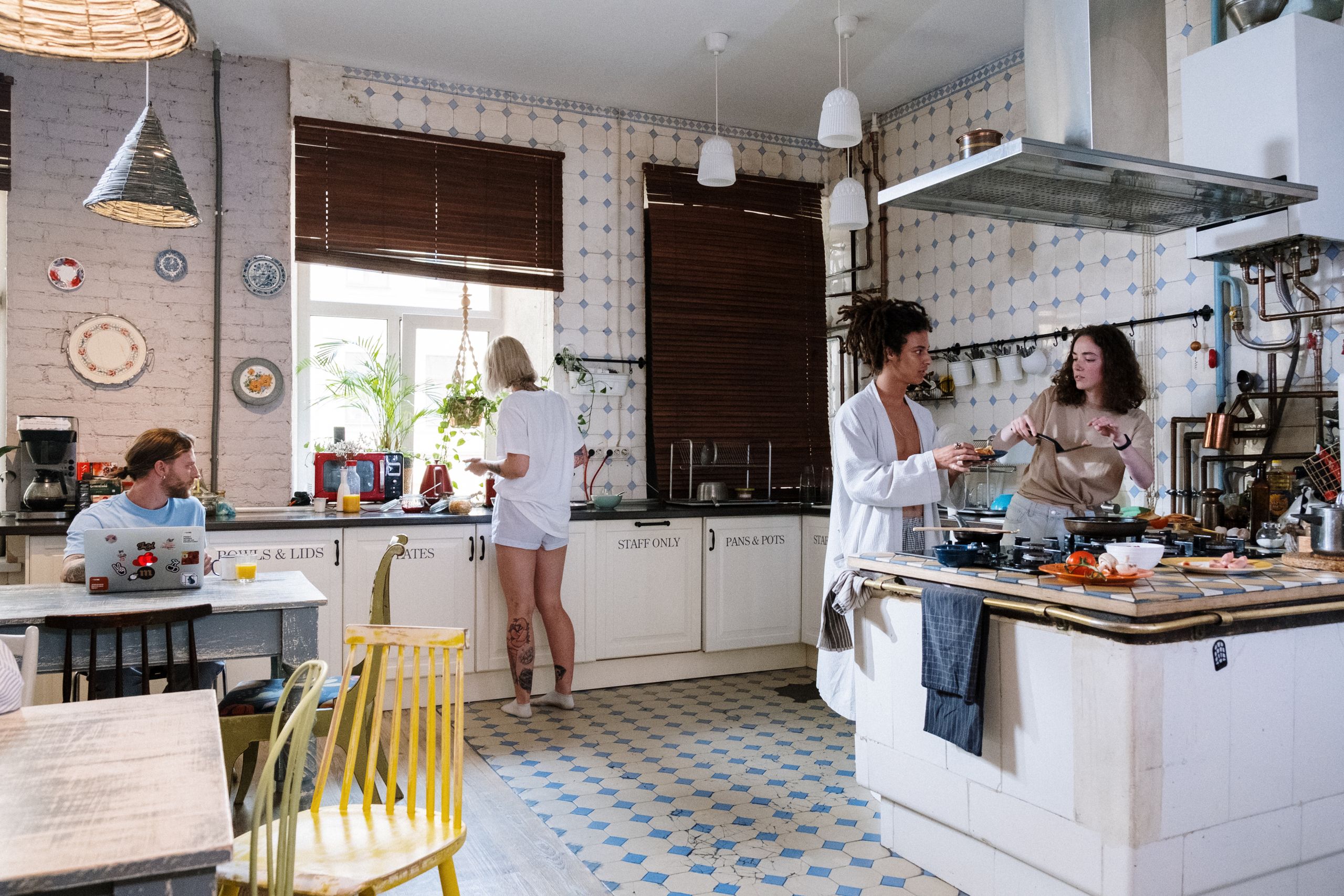 Good Hostel Kitchen - Friends enjoying a cozy day cooking together in a stylish kitchen setting.