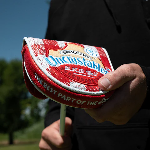 Limited-edition red L.A.B. Golf x Uncrustables putter headcover inspired by classic Uncrustables sandwich packaging.