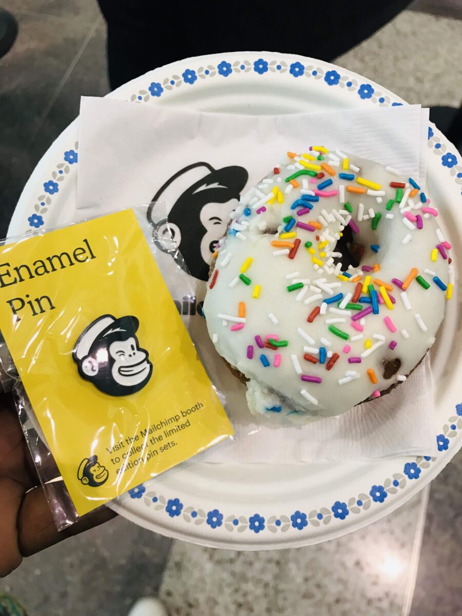 Mailchimp enamel pin and rainbow-sprinkle doughnut at Collision in Toronto