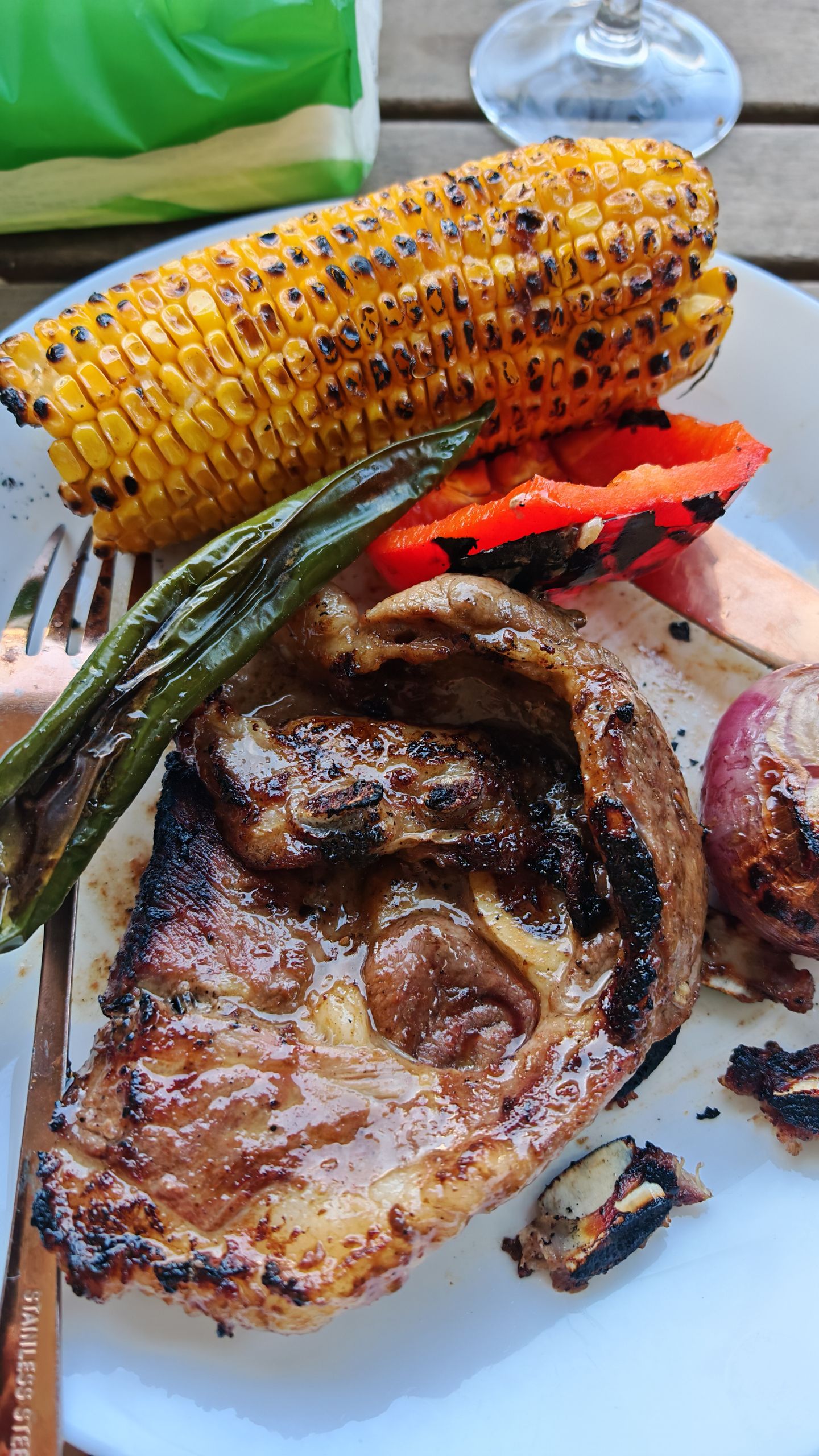 What I Eat When No One Is Watching - Juicy grilled beef steak served with roasted corn and peppers on a plate.