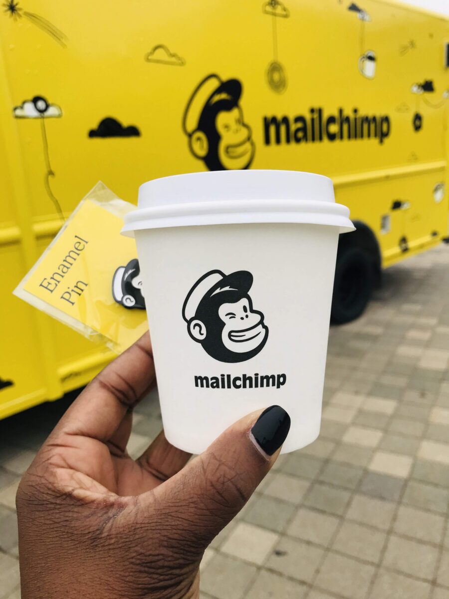 Hand holding a Mailchimp coffee cup at Collision in Toronto