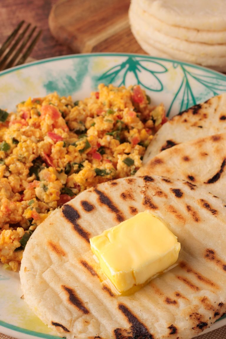 Navigating Cultural Identity: Growing up in a Colombian-American Household - Delicious Colombian arepas served with scrambled eggs and butter for a hearty breakfast.