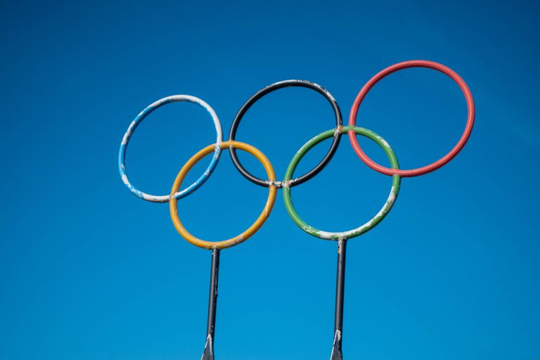 Olympic rings sculpture set against a clear blue sky in Lahti, Finland.